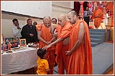 Swamishri blesses a young child