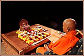 Swamishri turning the rosary in pooja