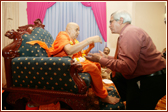 Lord Dholakia, President of the Liberal Democratic Party garlands Swamishri