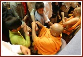 Sadhus tying rakhdis on devotees wrists