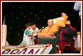 Swamishri blessing a child