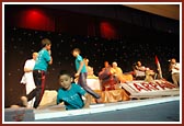 Children delighting and suprising Swamishri by appearing from under the stage