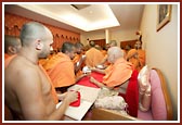 Swamishri serving prasad to the sadhus