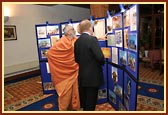 Atmaswarup Swami shows the posters and photographs of 'Mystic India' to Rt. Hon. Charles Kennedy MP