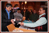 Volunteers distributing prasad