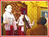 After Swamishri performed the murti-pratishta rituals in India, the deities are ritually being installed by sadhus in the mandir