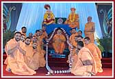 On behalf of the 64 saints who came for vicharan in March, saints present Swamishri a haar with 108 niyams