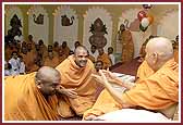 The participant saints receive blessings from Swamishri after the game