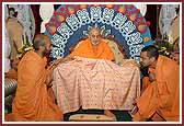  Swamishri is presented with a shawl with niyams taken by the San Jose Mandal  written on it. 