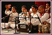  Yuvaks sing a kirtan in qawali style during the evening assembly  