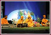Saints sing kirtans at the start of the Kishore/Kishori Din Assembly 
