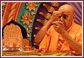   Swamishri applies chandlo to his forehead