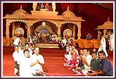 Devotees honor Swamishri with a garland  