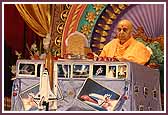   Swamishri turns the mala' vspace=