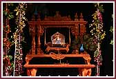 Shri Harikrishna Maharaj seated on a hindolo 