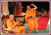 Swamishri and Pujya Ghanshyamcharan Swami play the kartals  