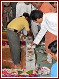 Devotees place bricks in the foundation