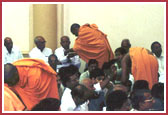 Saints tieing Raakhdi to devotees in the Hindu tradition of Rakshabandhan