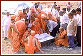 Swamishri is informed about the plans regarding the construction from the ground level