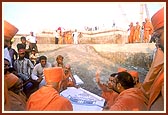 Swamishri is informed about the plans regarding the construction from the ground level