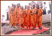 Swamishri joyously descends after the stone-laying ceremony 