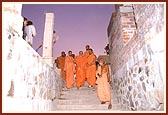 Swamishri descends the steps to the underground construction area