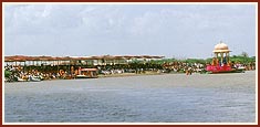 Sadhus and devotees engaged in darshan by the river bank