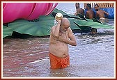 Swamishri takes the customary bath