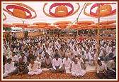 Devotees seated in the assembly